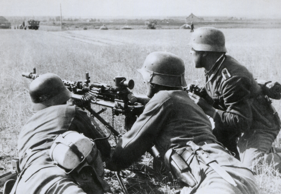German soldiers fire a machine gun during the Nazi invasion of the Soviet Union (Russia). Summer 1941, during World War 2. (BSLOC_2014_8_15)